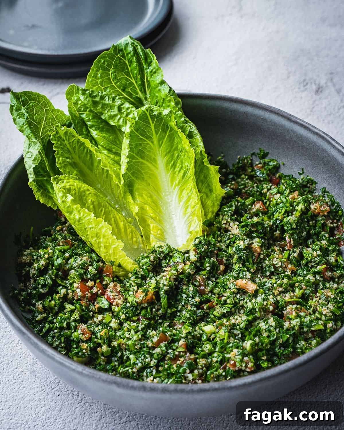 Tabbouleh salad in a bowl with romaine lettuce hearts. 