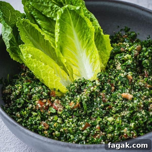 Tabbouleh salad in a bowl with romaine lettuce hearts.