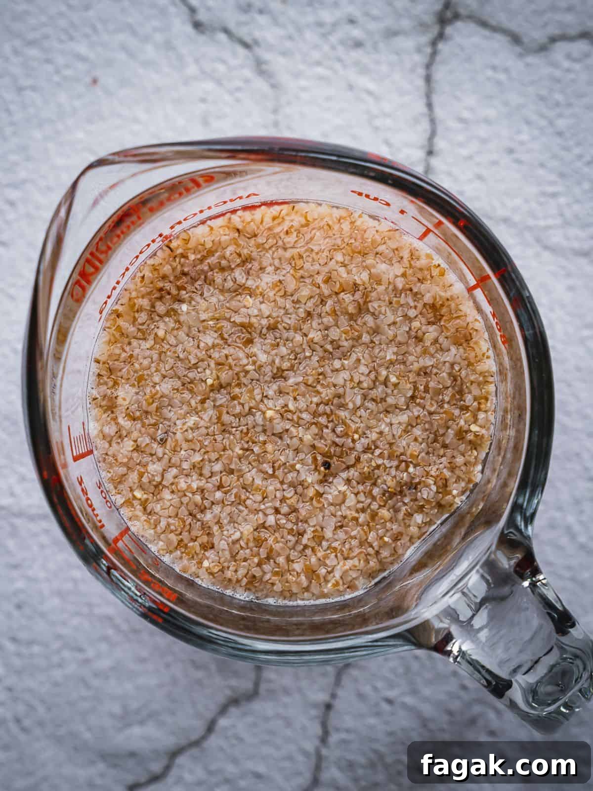 A Pyrex measuring cup with bulgur soaking. 
