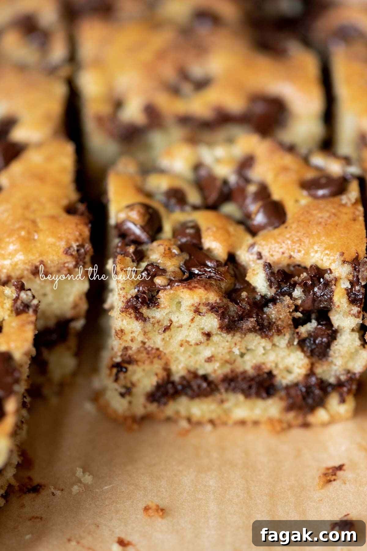 Sliced chocolate chip coffee cake placed on brown parchment paper.