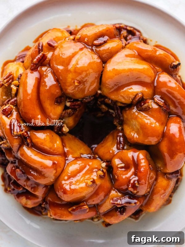 Overhead view of butterscotch bundt rolls on white dessert plate and white background.