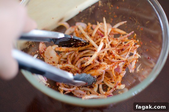 Toss the onions with the salad dressing.