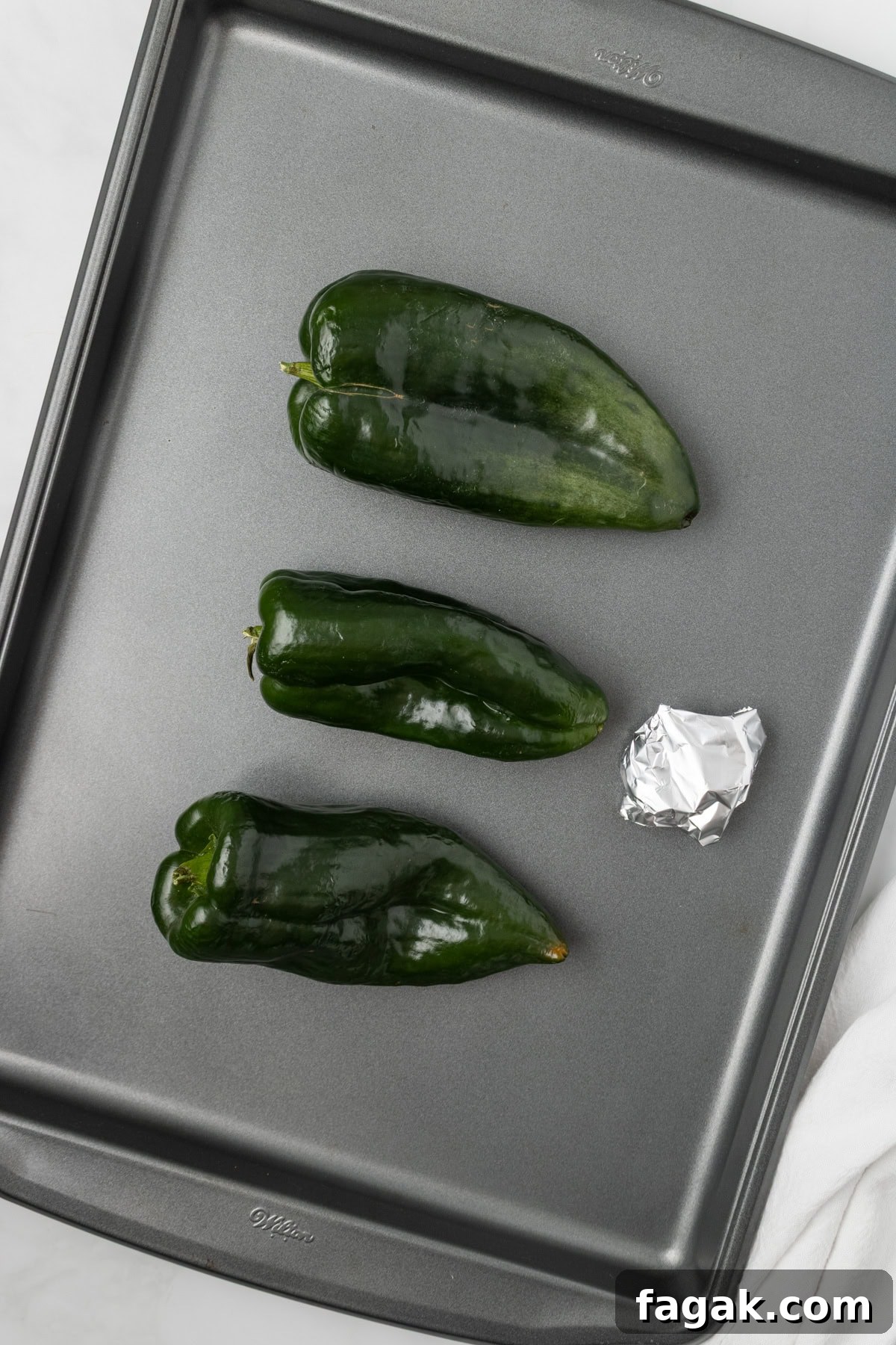 An overhead image of roasting the poblano peppers and garlic in the oven.