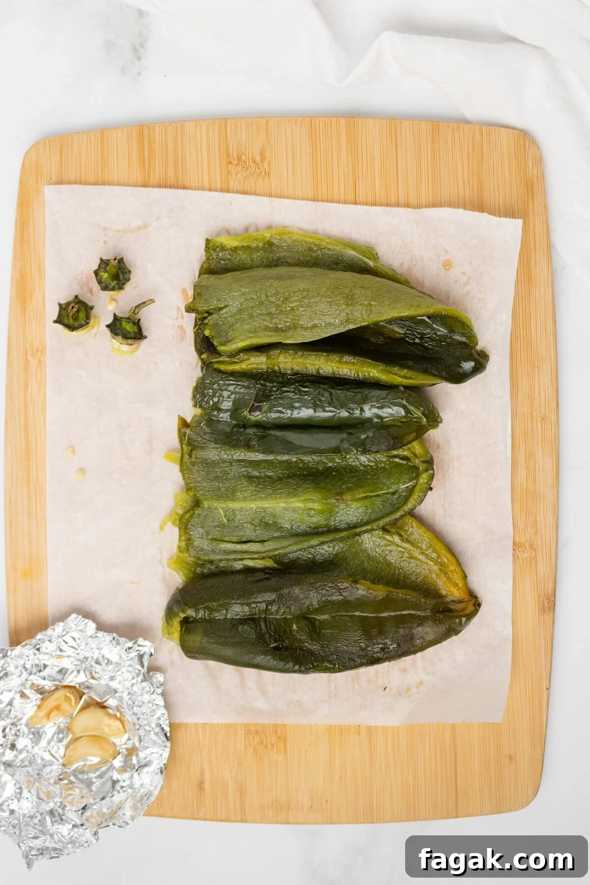 An overhead image of removing the seeds of the poblano peppers.