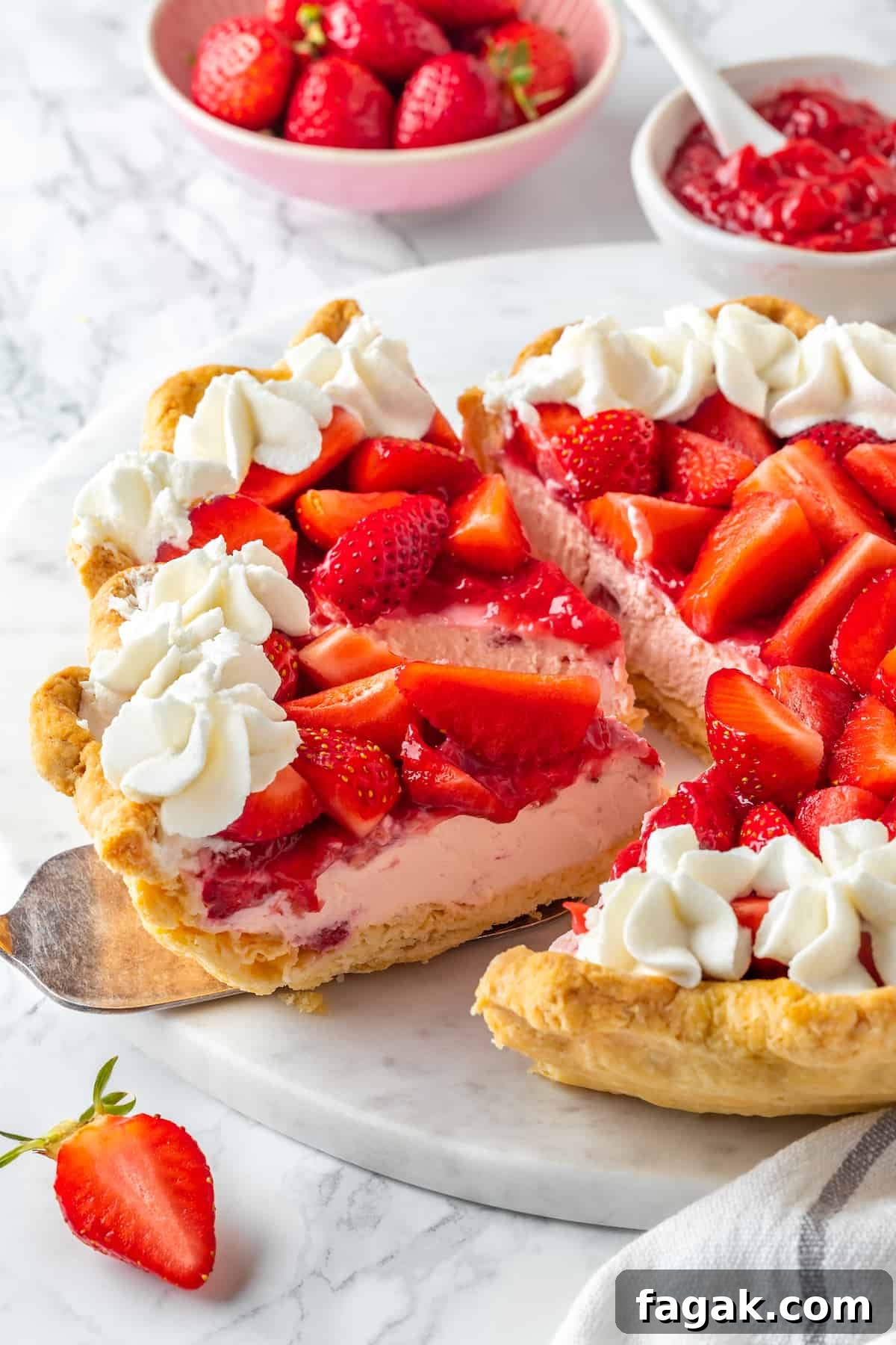 Slice of strawberry cream pie being lifted from the rest of the pie