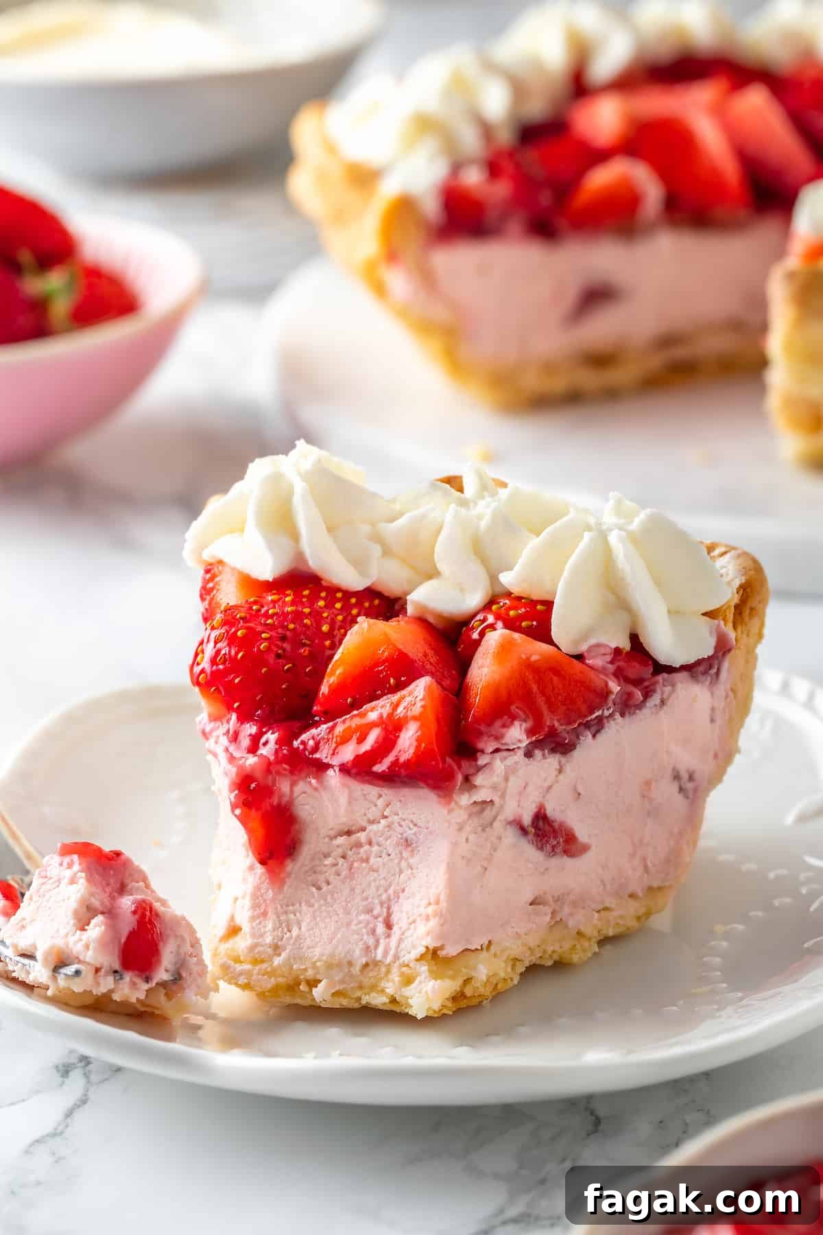 Slice of strawberry cream pie on plate with tip on fork