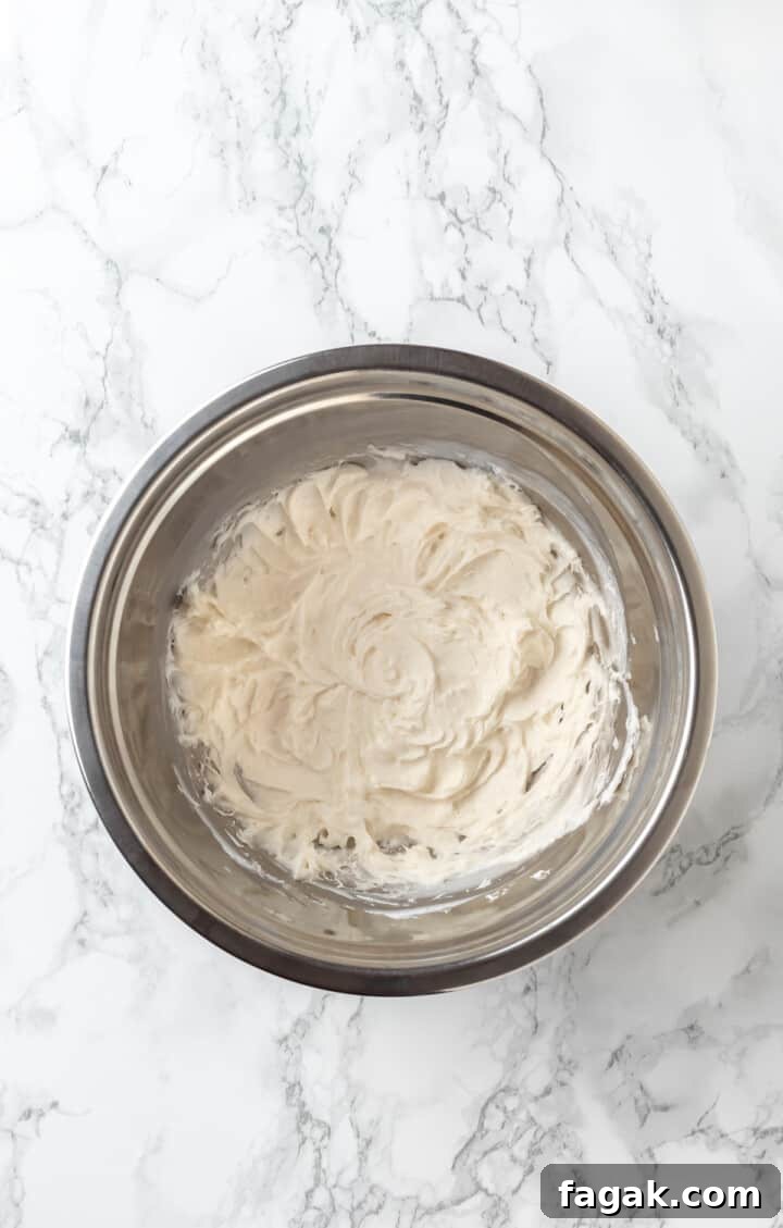 Overhead view of whipped cream cheese mixture in mixing bowl