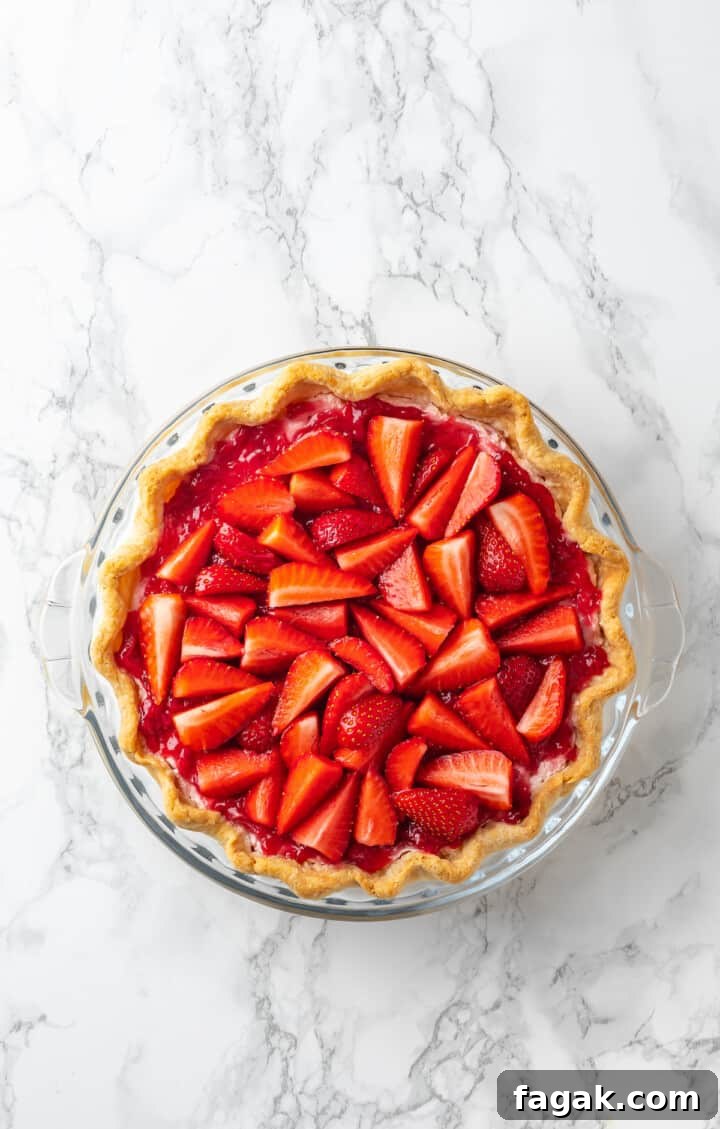 Overhead view of strawberry cream pie before adding whipped cream