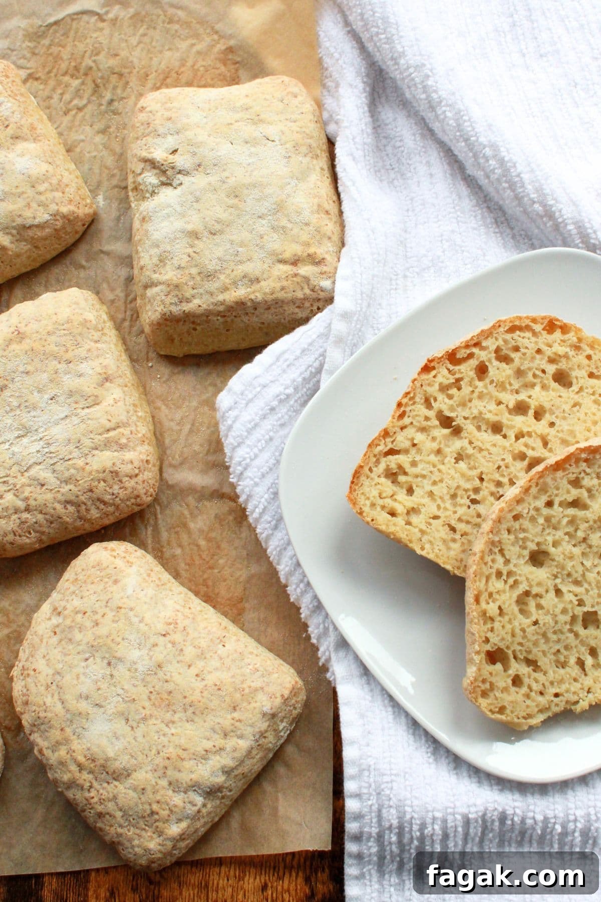 Top down view of gluten-free ciabatta on parchment paper and plate.