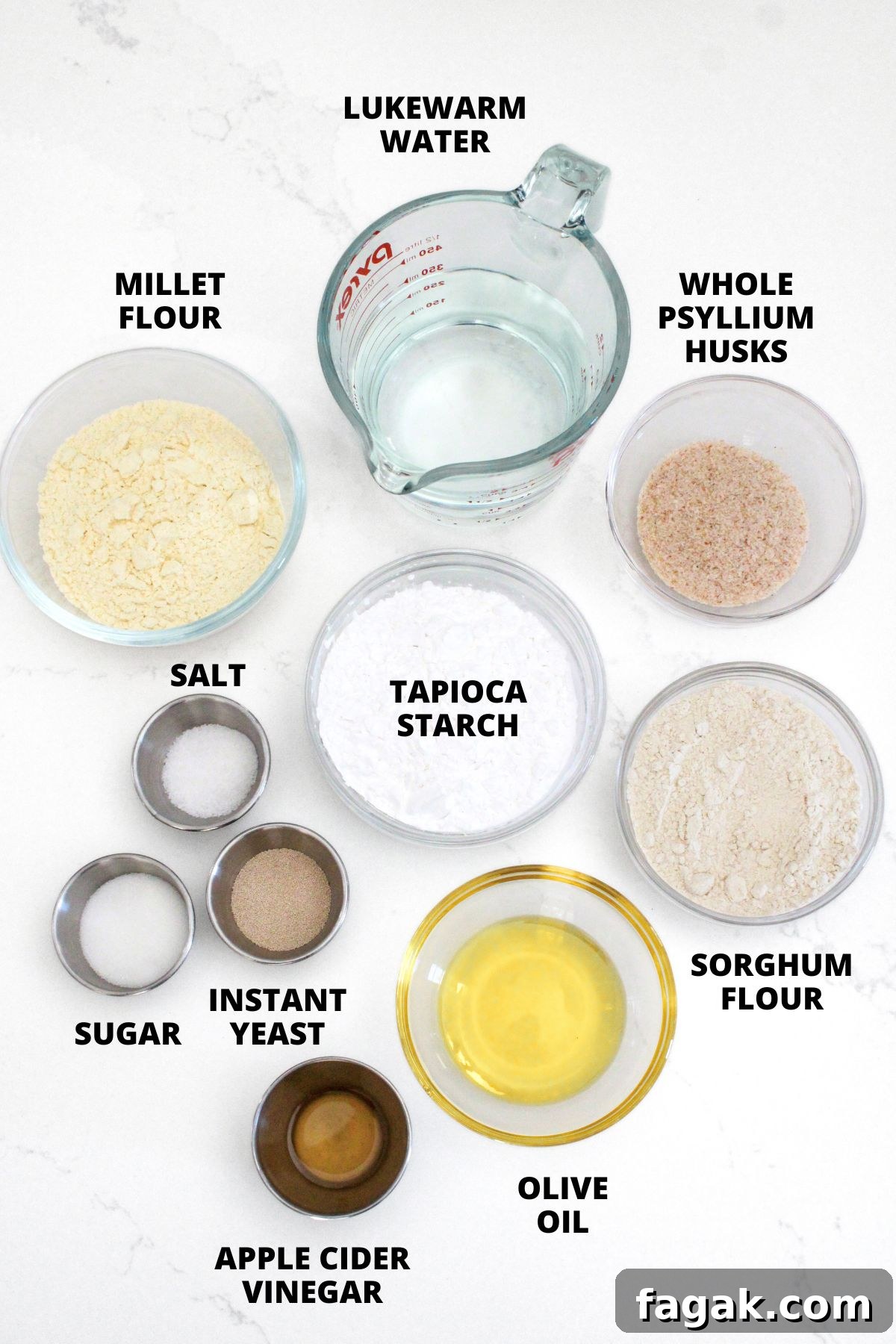 Ingredients for gluten-free ciabatta recipe laid out on white board.