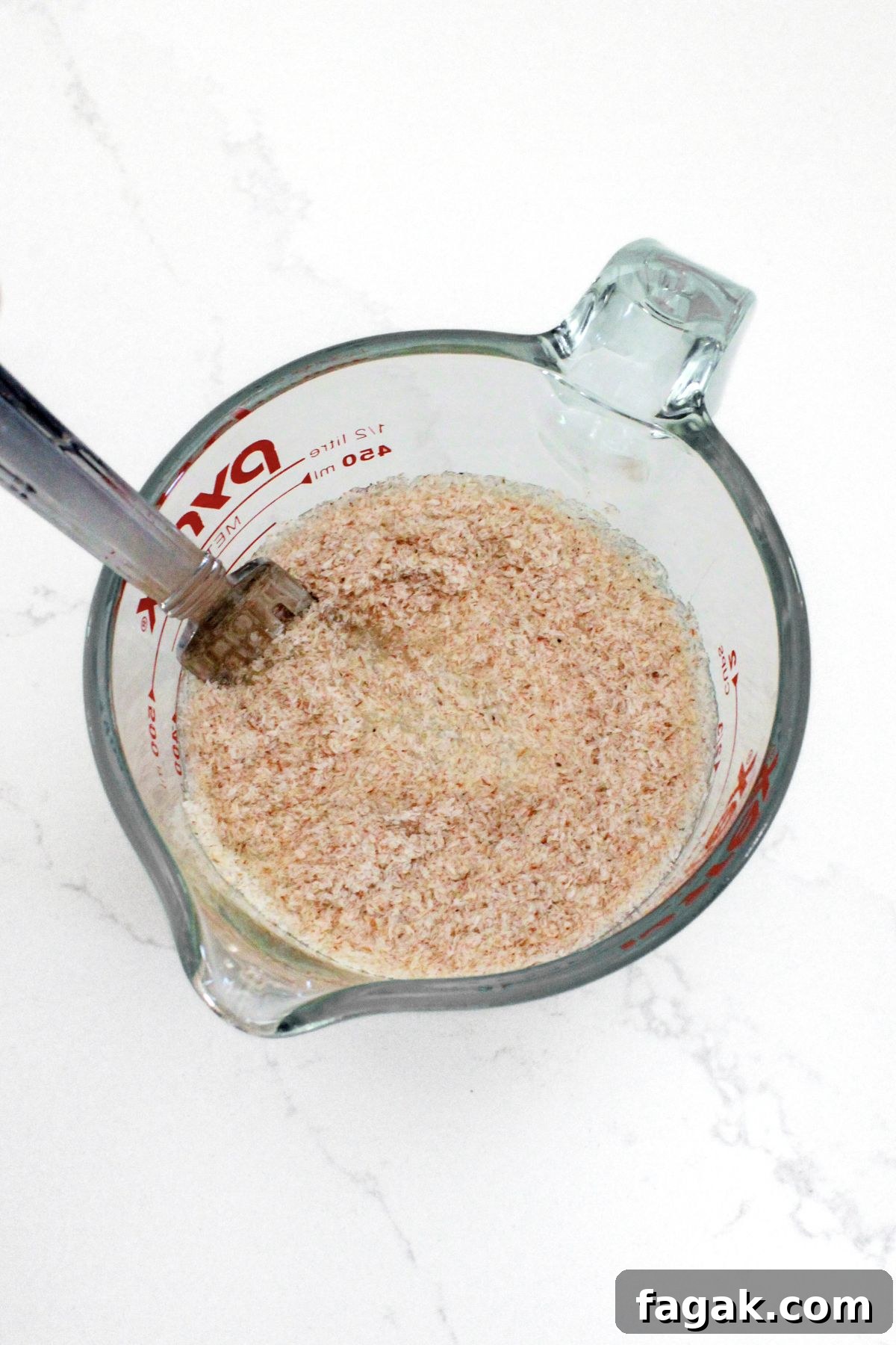 Mixing whole psyllium husks with water in bowl.
