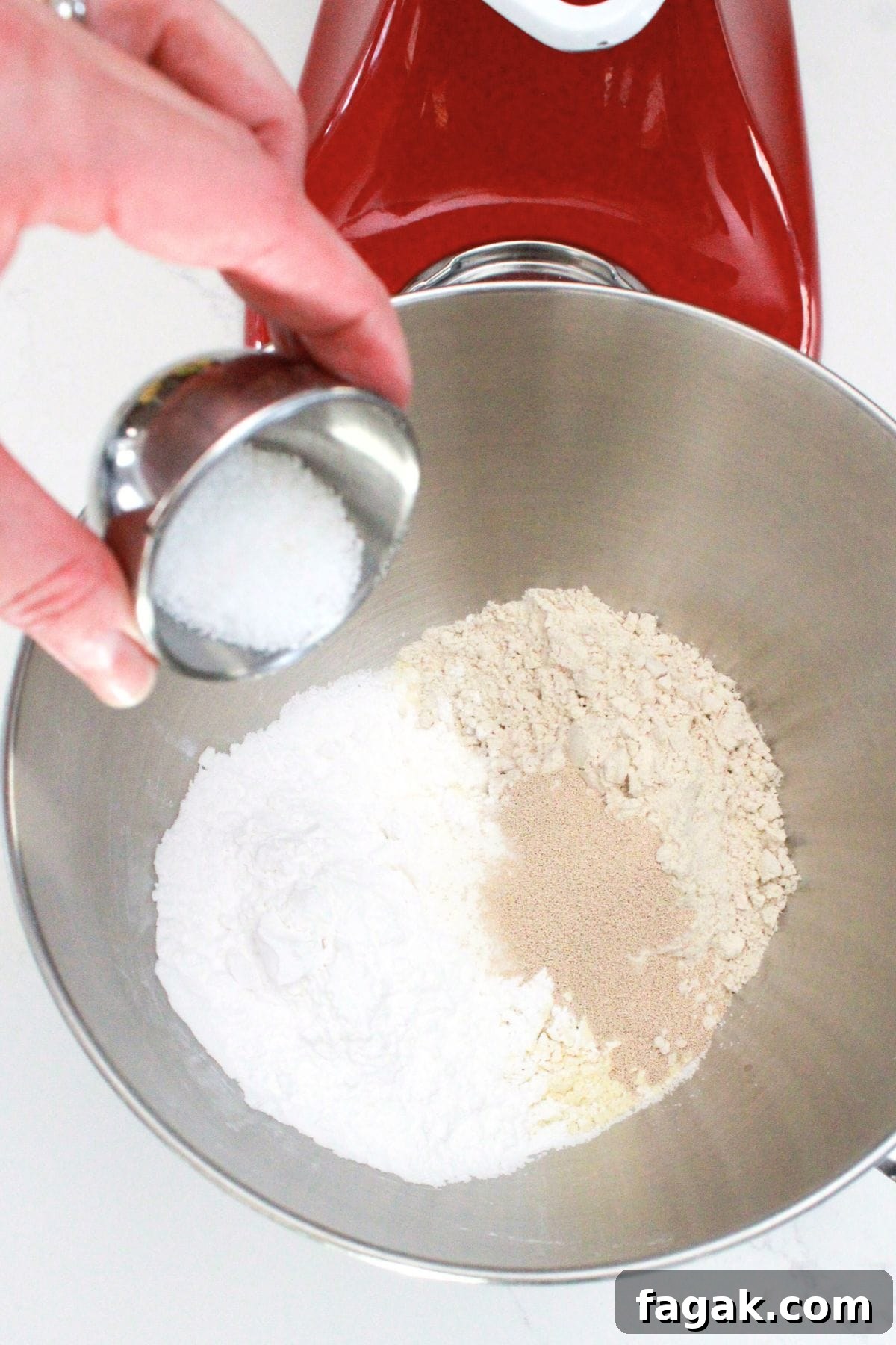 Adding sugar to stand mixer with flour and yeast.