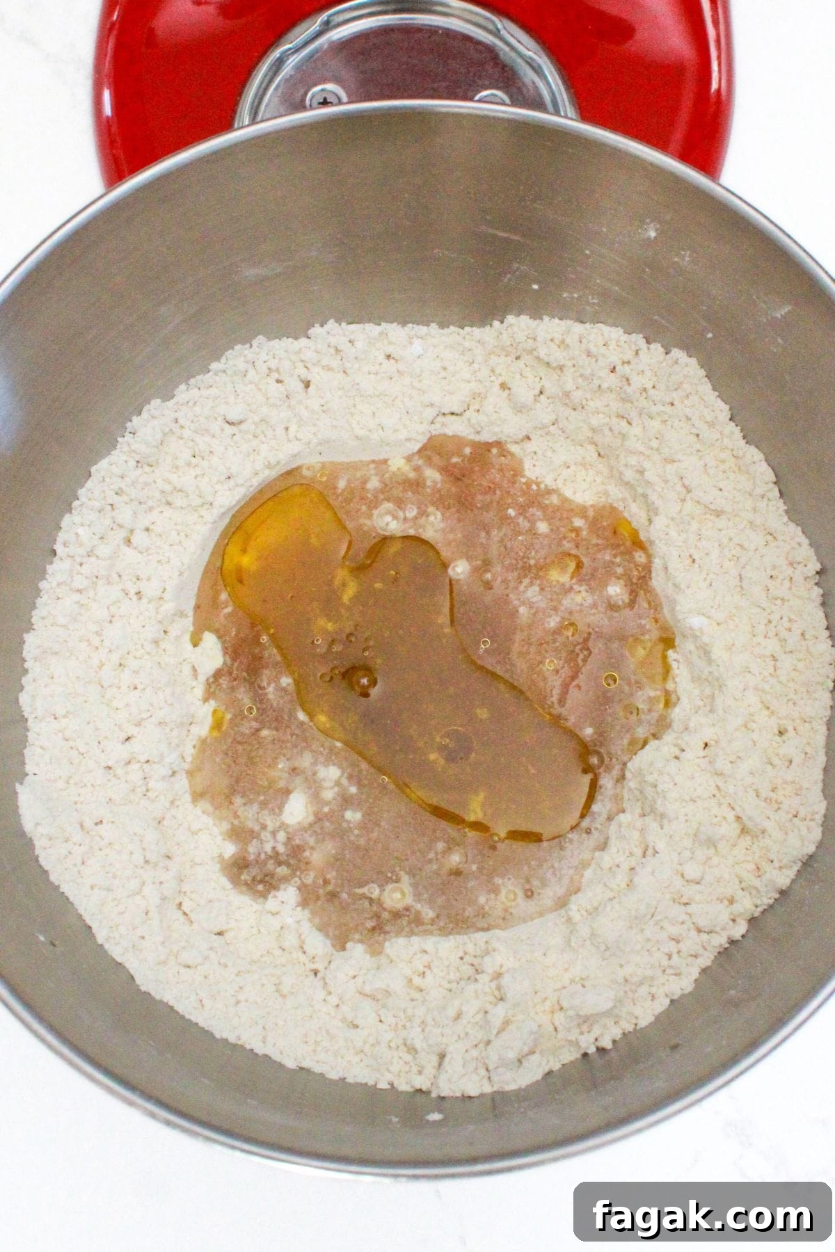 Mixing wet ingredients with flour mixture in stand mixture.
