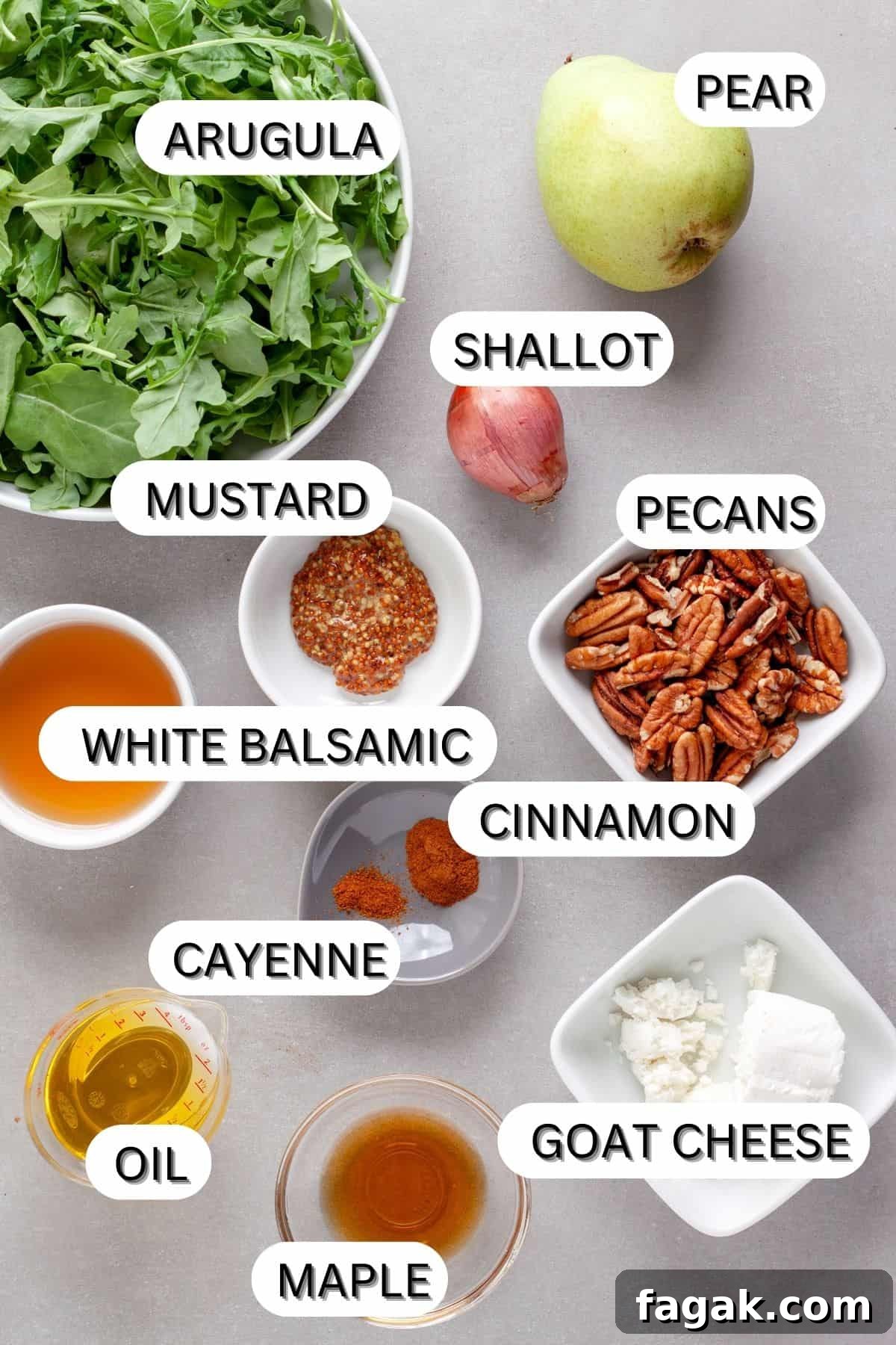 Ingredients for an arugula and pear salad on a gray table.