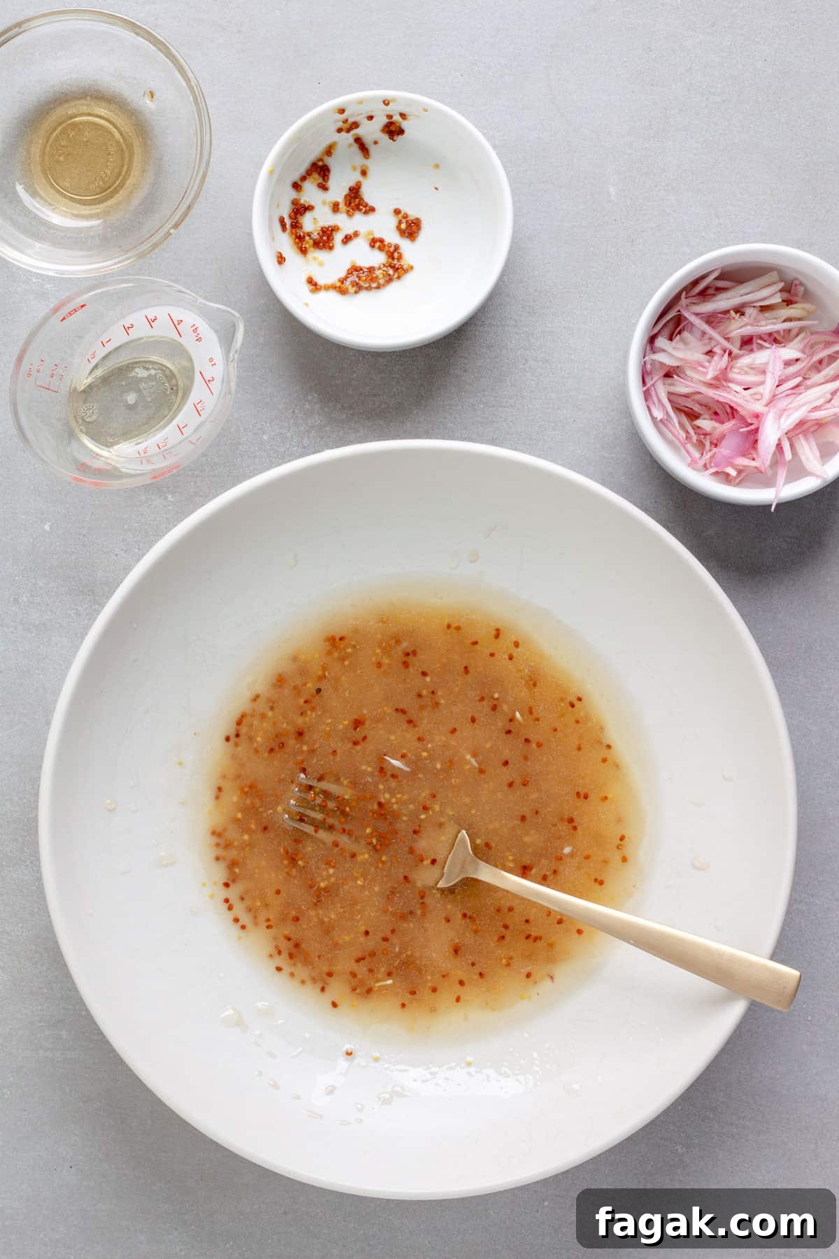 A white balsamic vinaigrette whisked together in a medium bowl.