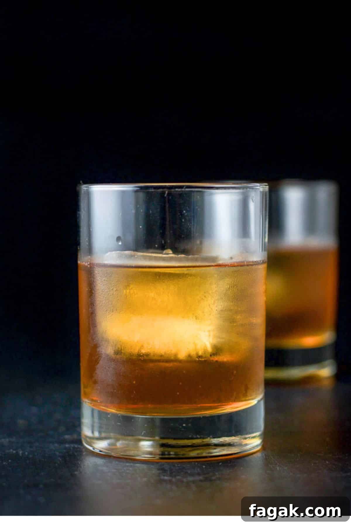 How to Make a Classic Godfather Cocktail: Recipe & Tips 2 Vertical view of two staggered glasses filled with the amber drink