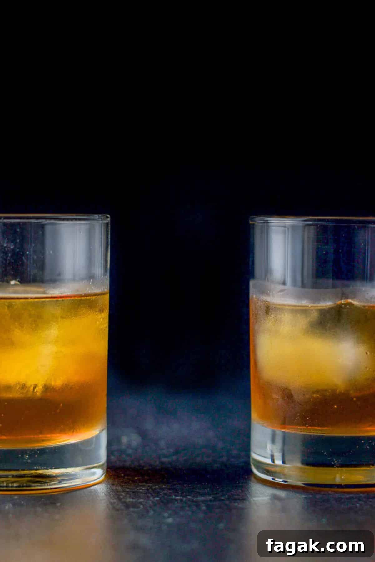 How to Make a Classic Godfather Cocktail: Recipe & Tips 6 two double old-fashioned glasses filled with the cocktail one on the left and one on the right. You can only see half of each glass