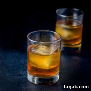 How to Make a Classic Godfather Cocktail: Recipe & Tips 7 Two old fashioned glasses filled with the godfather cocktail - square