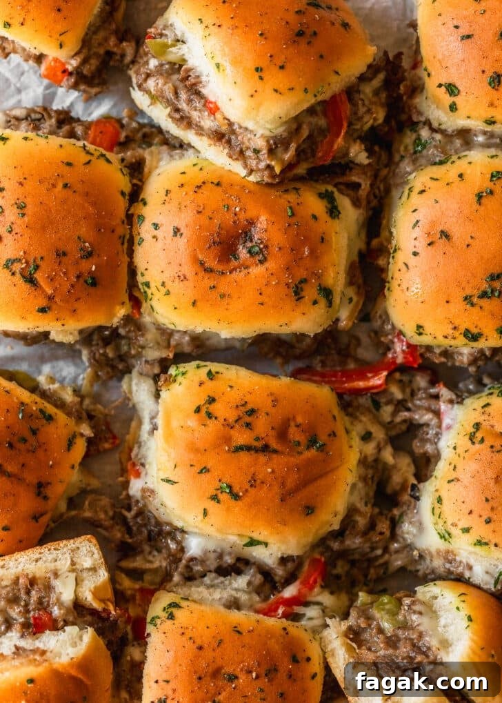 Sliced Philly cheesesteak sliders.
