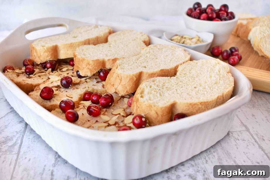 layering the bread for cranberry almond baked french toast