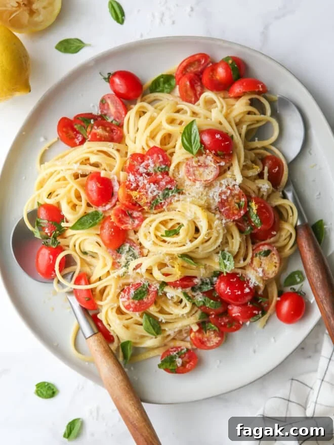 lemon pasta with tomatoes and basil on a plate in utensils
