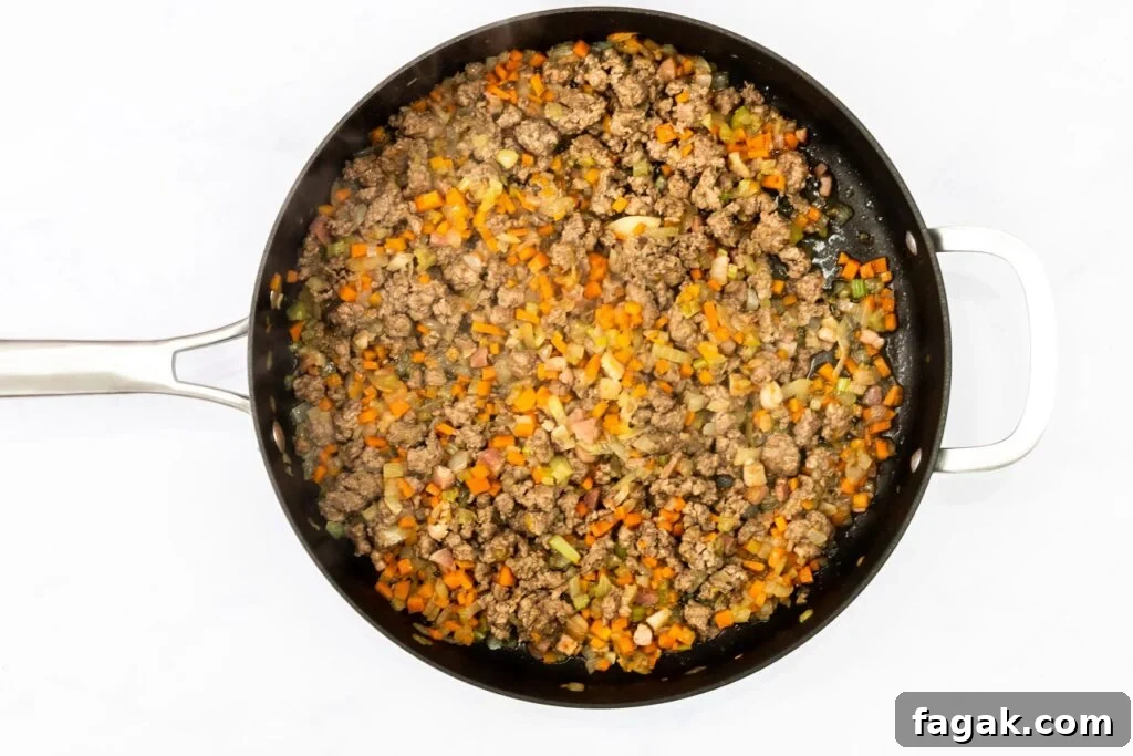 browned lamb and veggies in a saute pan