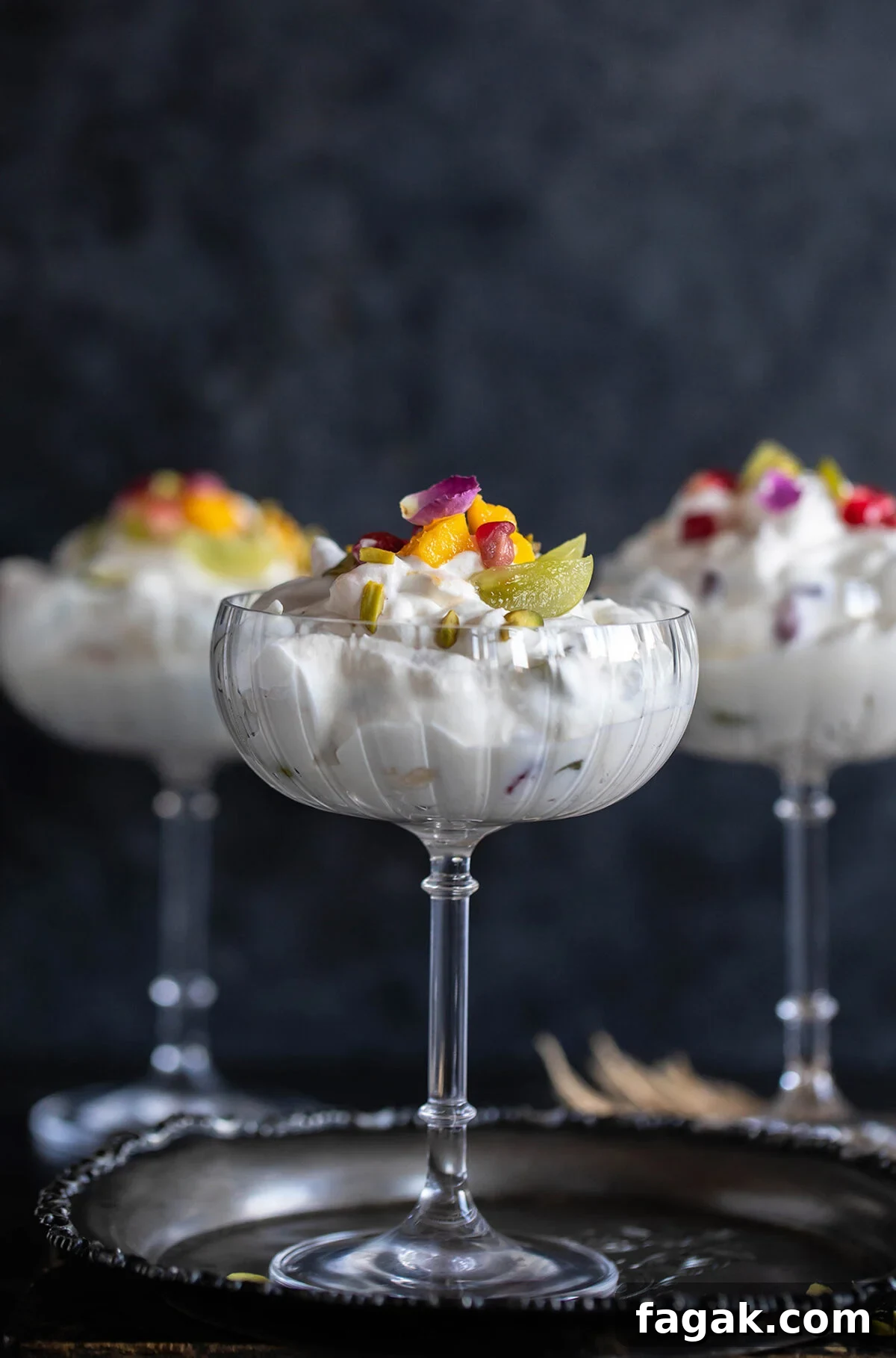 3 glasses filled with whipped cream and fruits