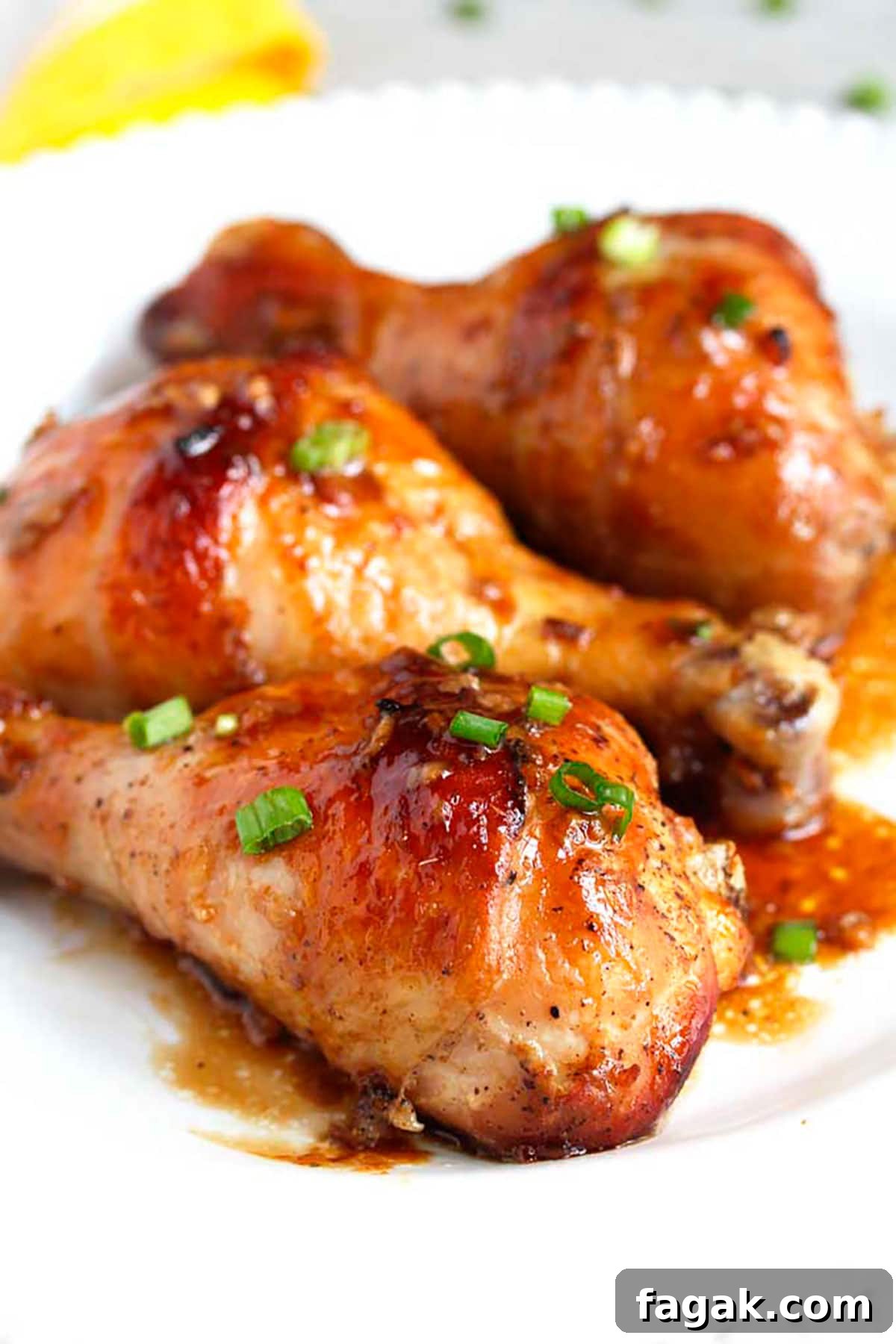 Dinner plate filled with golden brown, crispy and juicy baked chicken drumsticks.