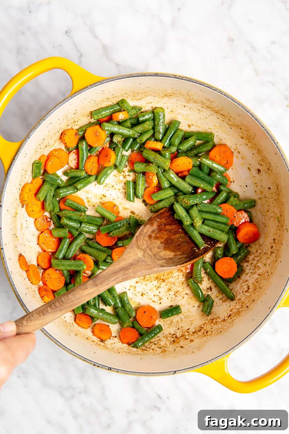 Sautéed green beans and carrots in an enameled dutch oven.