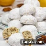These buttery and crumbly shortbread style cookies dotted with chopped pecans then rolled in powdered sugar are simply irresistible! The addition of fresh lemon flavor makes these pecan snowball cookies even more scrumptious, you can't just have one!