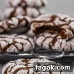 Just 4 ingredients to make these soft, chewy, sweet and oh-so- yummy – Chocolate Crinkle Cookies! Super easy to make, and perfect for the holiday season! Great cookies for a cookie exchange.