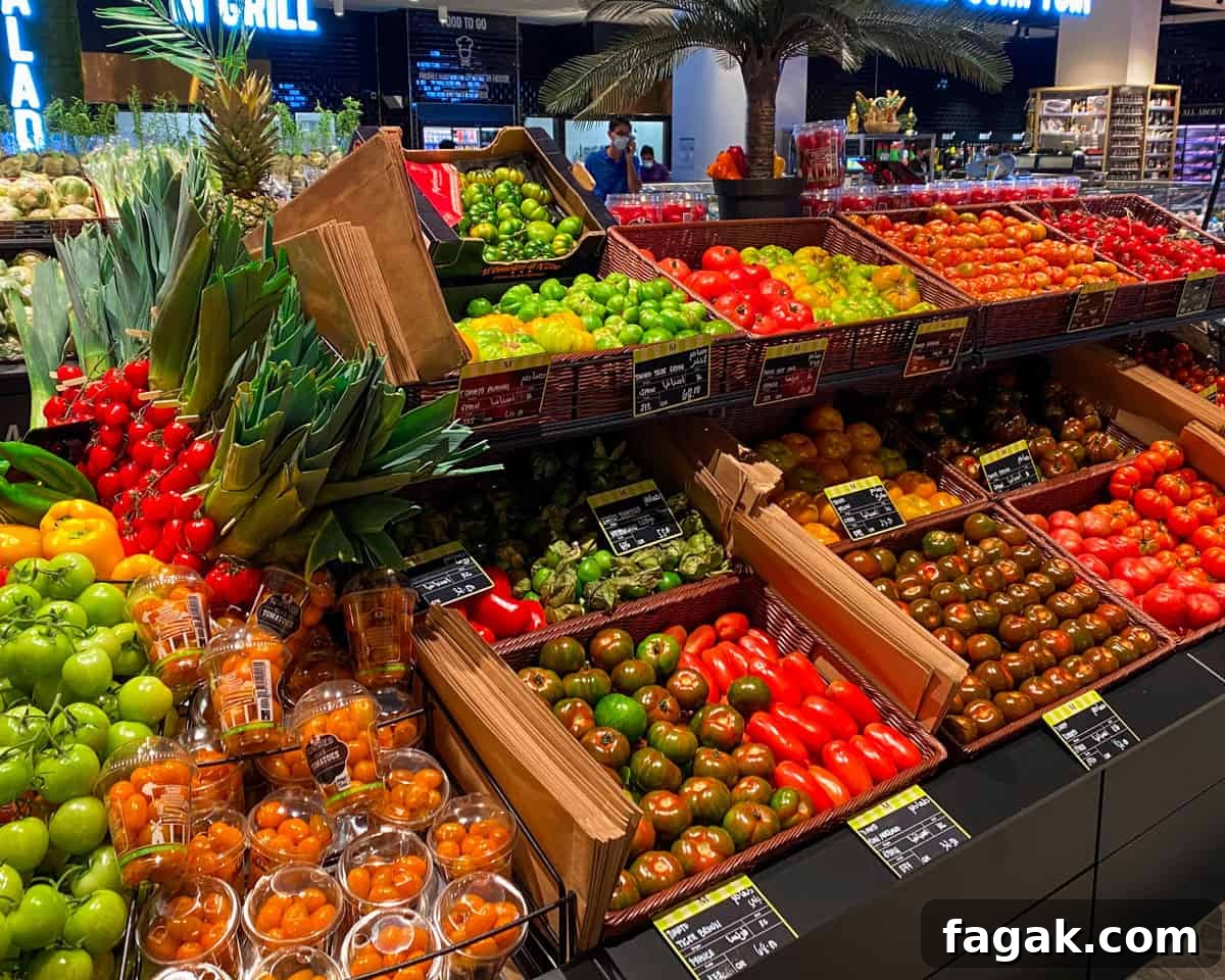 Photo of the tomato section of the supermarket with vibrant colours of different varieties of tomatoes.