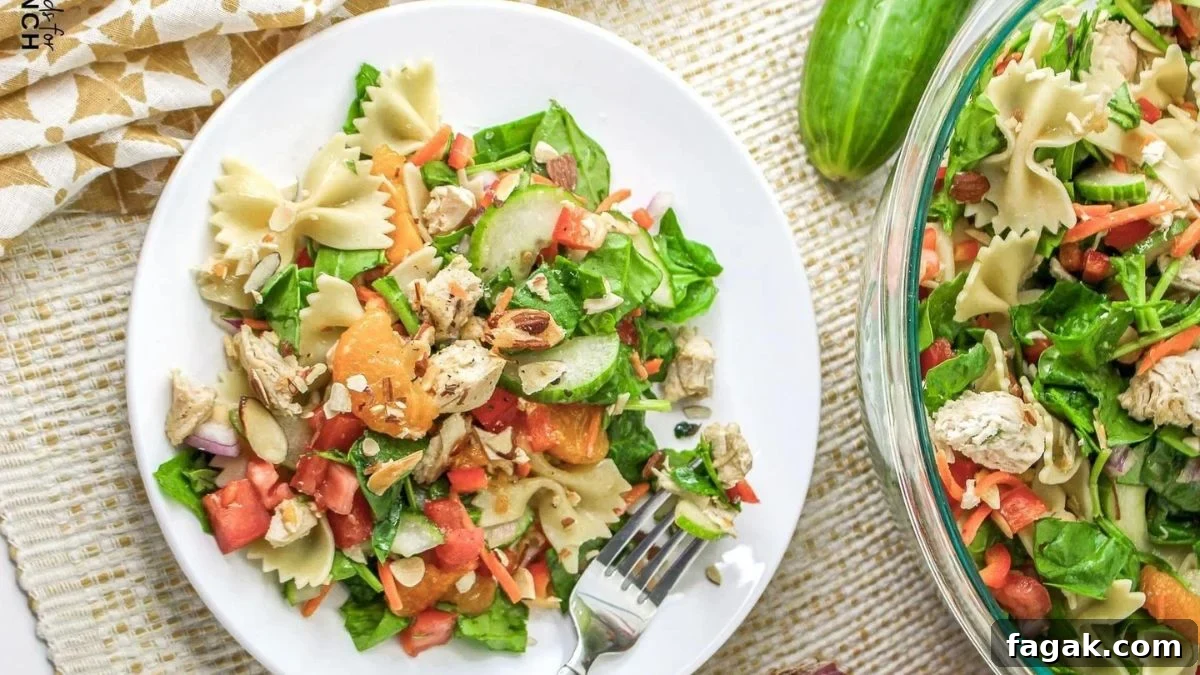Mandarin chicken pasta salad on a white plate.