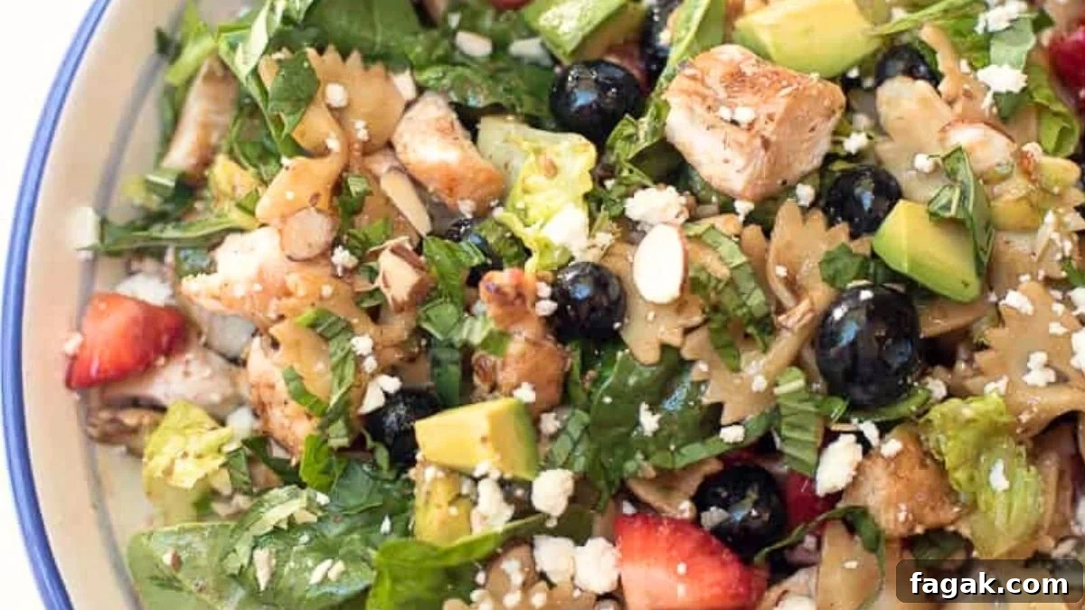 Chicken berry salad served in a white bowl.