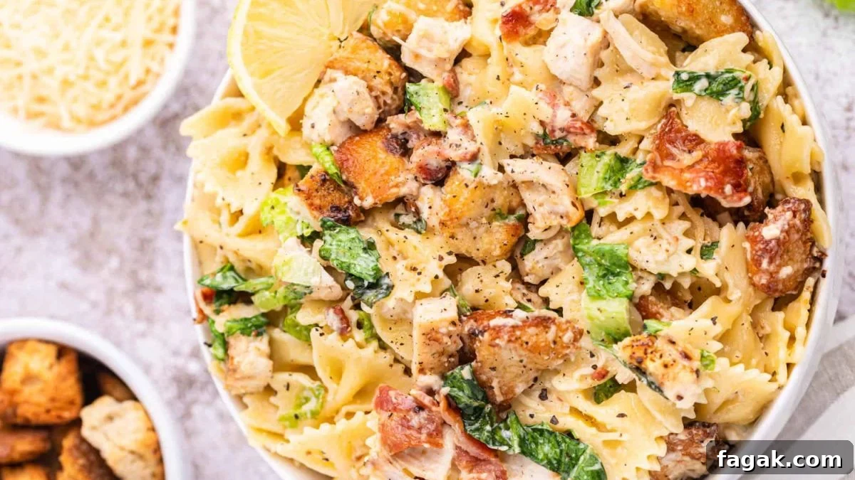 Chicken caesar pasta salad in a white bowl.