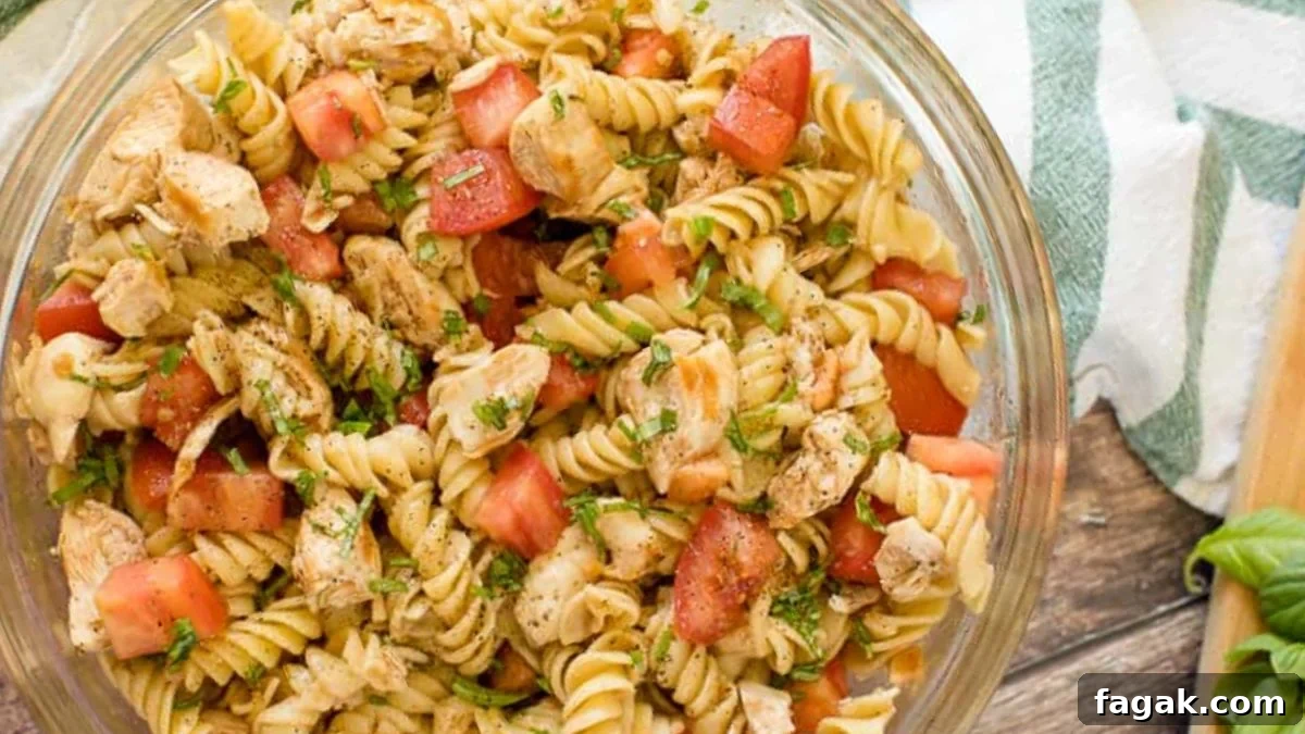 Bruschetta Chicken Pasta Salad in a glass bowl.