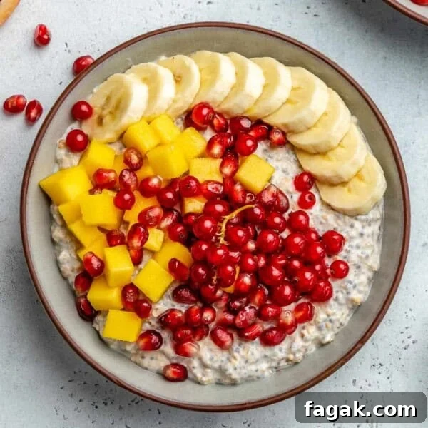Creamy Mango Chia Pudding Recipe for Tropical Breakfast 19 top view of oatmeal in a bowl with banana mango and pomegranate toppings