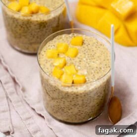 Creamy Mango Chia Pudding Recipe for Tropical Breakfast 22 a cup of mango chia pudding topped with chopped mango.