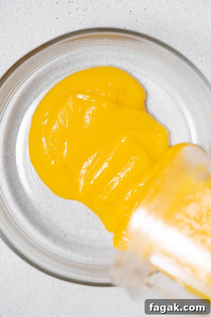 Creamy Mango Chia Pudding Recipe for Tropical Breakfast 7 pureed mango being poured over a bowl