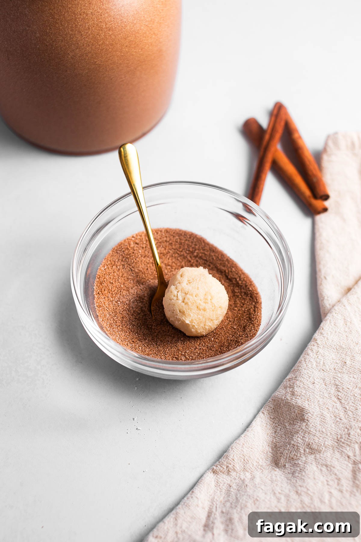 Rolling dough in cinnamon sugar