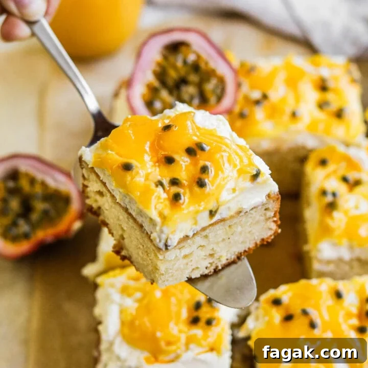 Slice of fluffy sour cream cake topped with mascarpone frosting and passion fruit