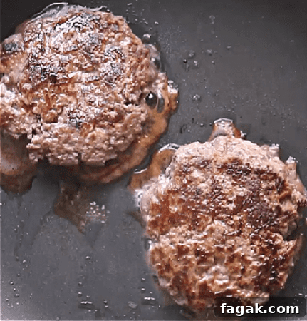 burgers cooking in skillet.