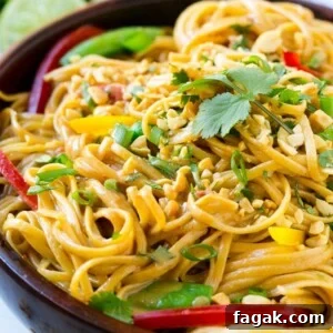 Thai peanut noodles with colorful vegetables.