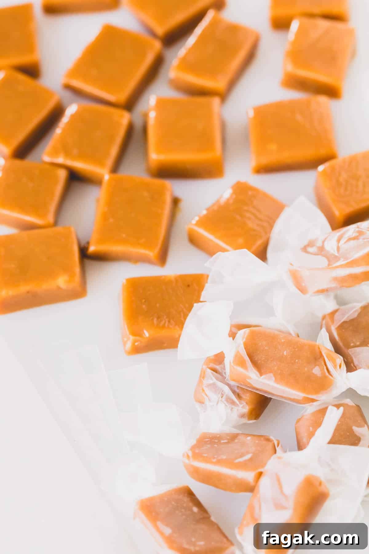 Cardamom caramel candies, some wrapped with parchment paper.