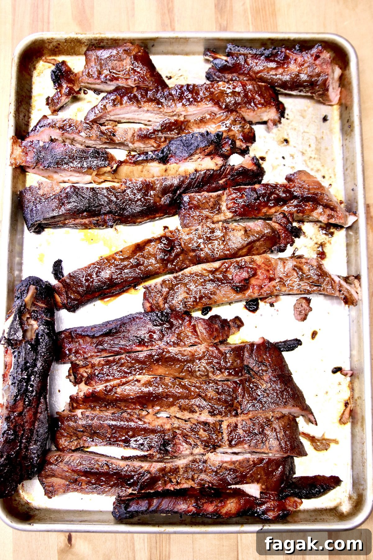 Grilled Spare Ribs with Mop Sauce grilled spare ribs on a rimmed baking sheet.