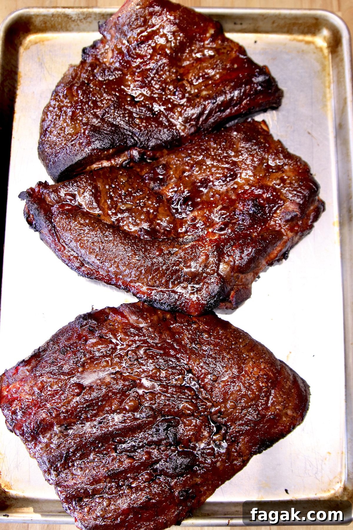 BBQ Mop Sauce for grilled spare ribs. Grilled Spare Ribs in thirds on a sheet pan.