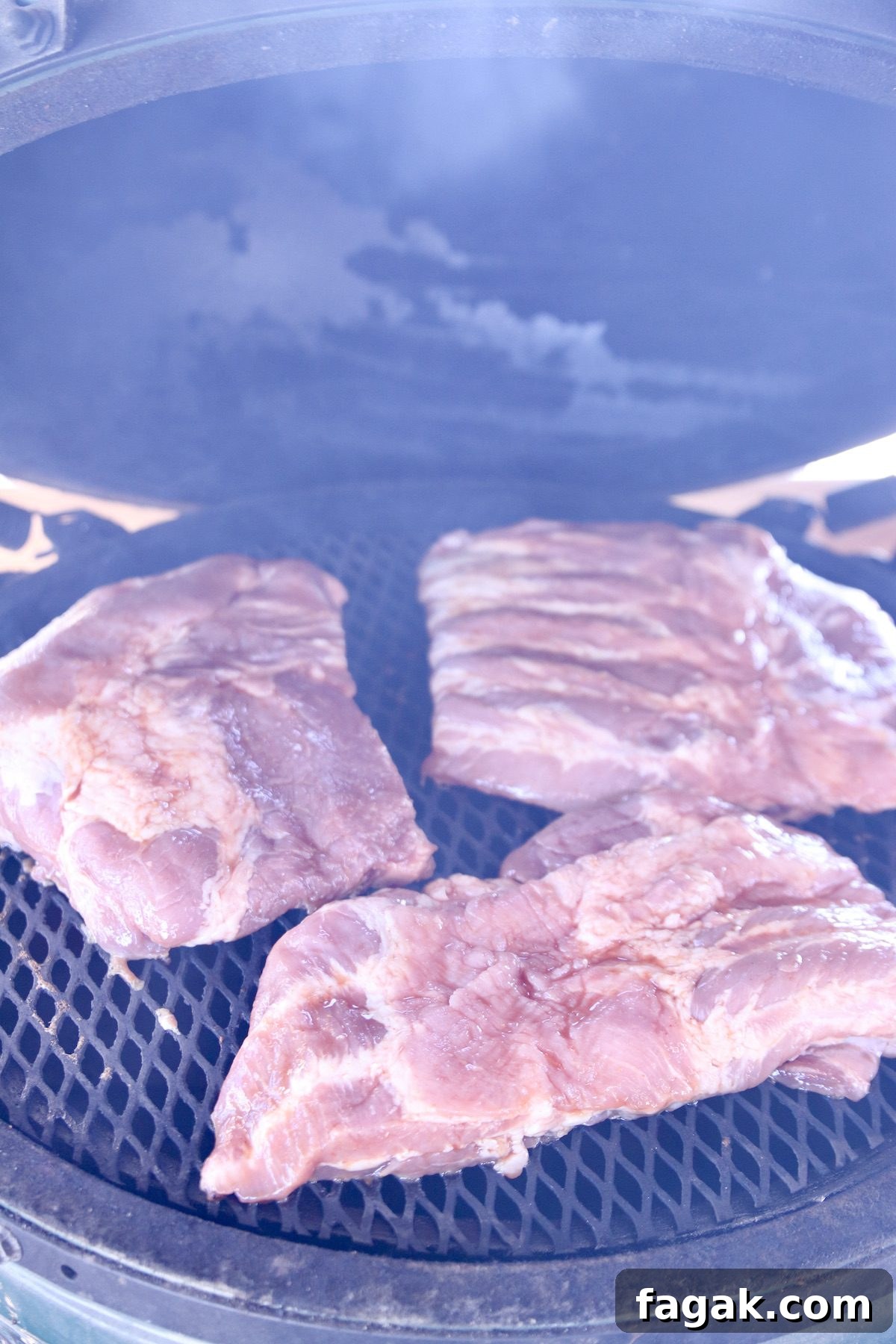how to grill tender and juicy spare ribs with bbq mop sauce. spare ribs cut into thirds on a grill.