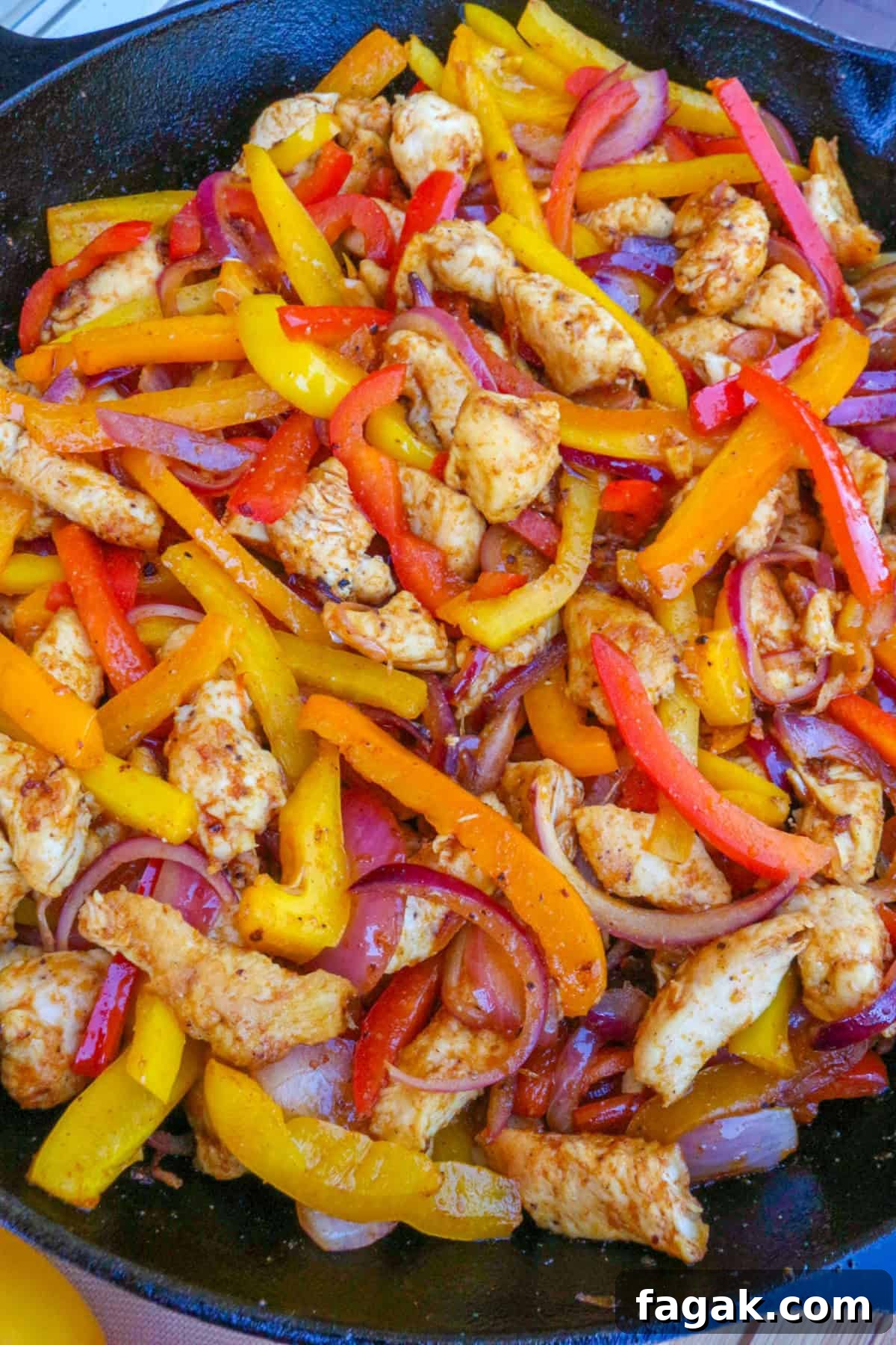 chicken fajitas with bell peppers in a cast iron