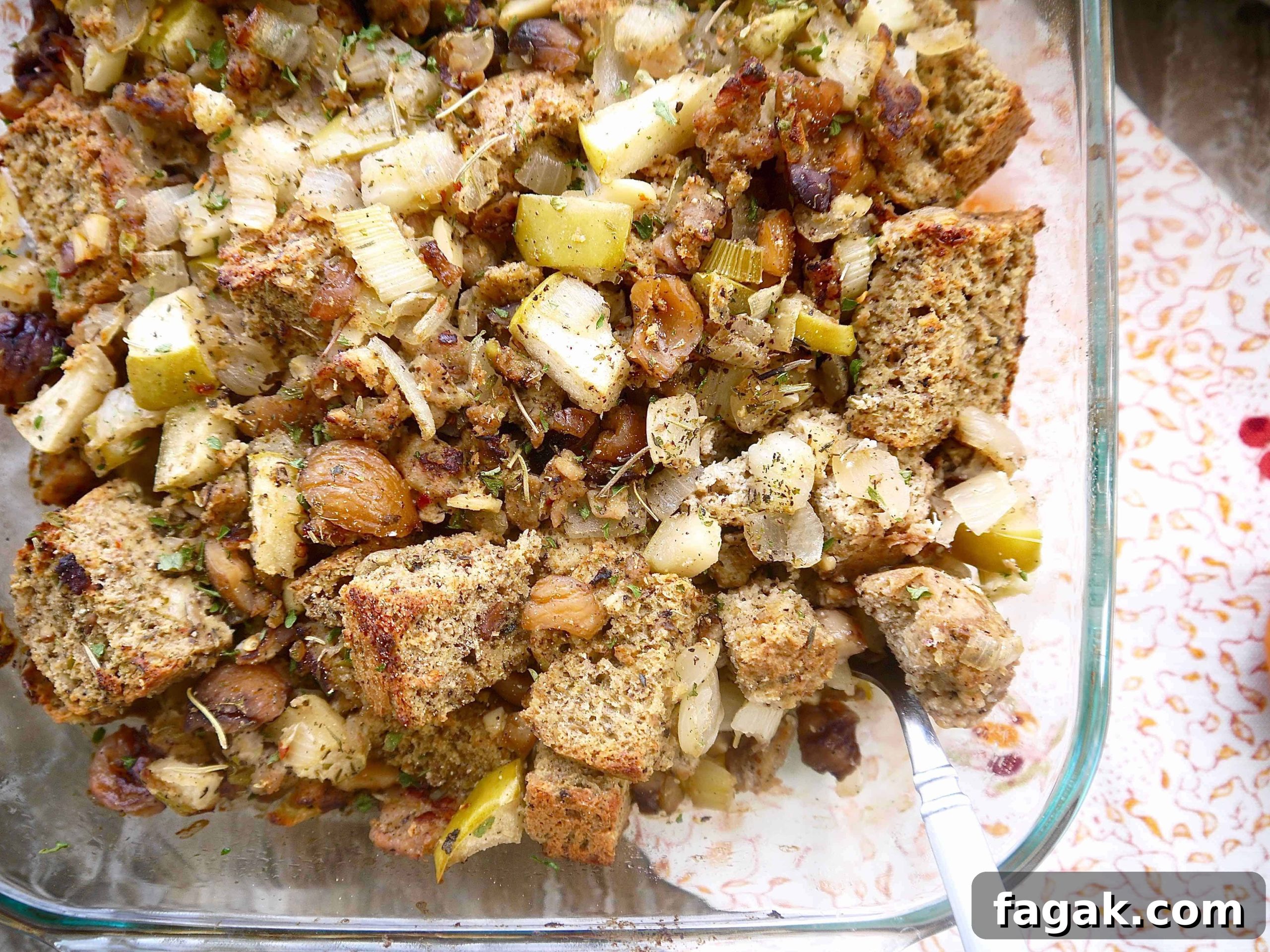 Paleo stuffing with sausage, apple, chestnut in a large baking pan.
