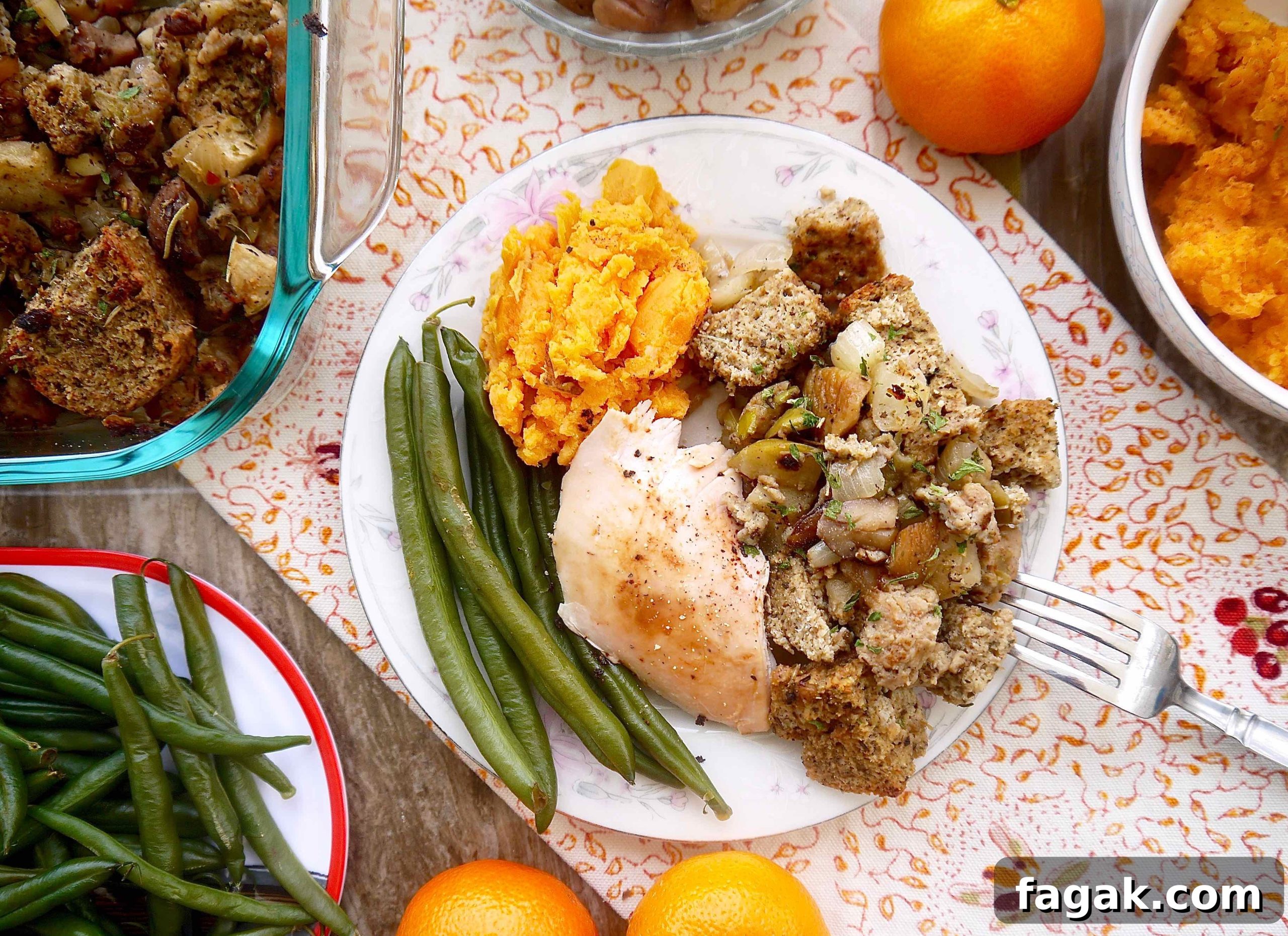 Paleo sausage stuffing on a plate with turkey, mashed potatoes and green beans.